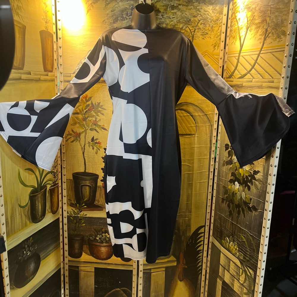 Black and White Bell Sleeve Dress with peek a boo slit in the back.